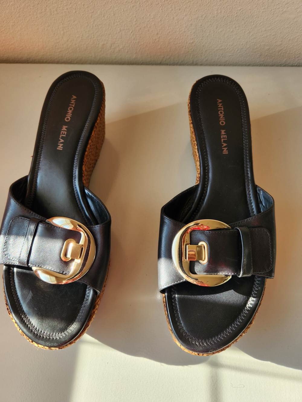 ANTONIO MELANI Black Leather Wedge Slide with Gold Buckle Accent